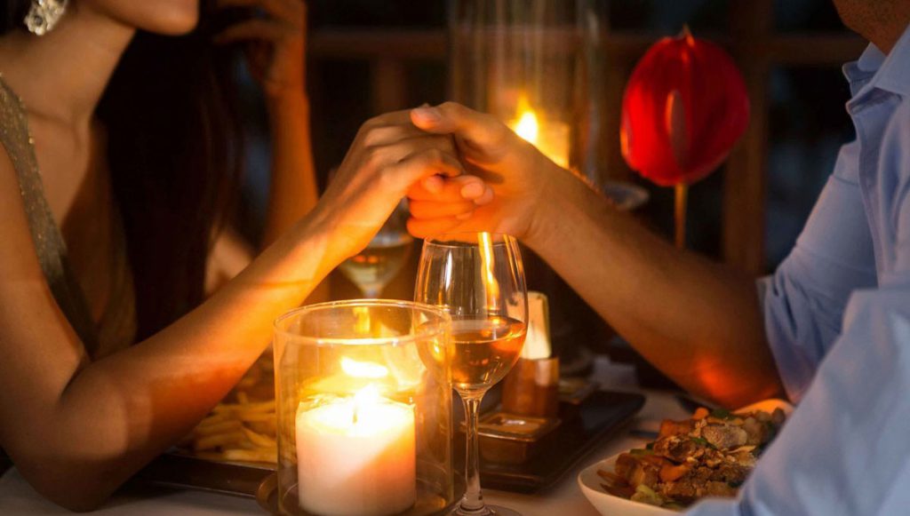 Image of happy caucasian couple taking selfie photo with flowers while  having romantic candlelight dinner at home Stock Photo - Alamy